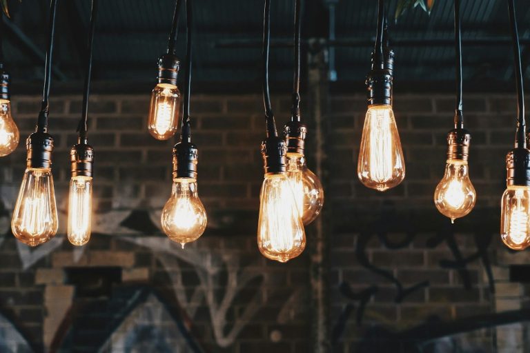 Vintage light bulbs hanging from a ceiling, casting a warm glow.